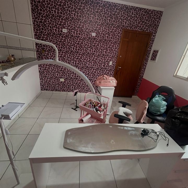 Mesa de atendimento do studio com luminária e cadeira